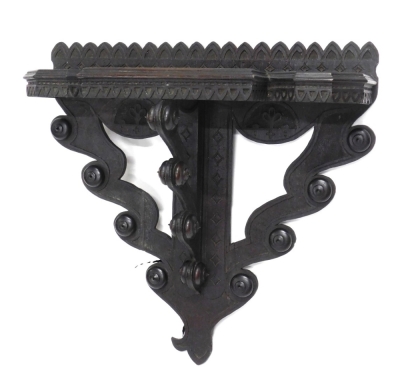 A 19thC heavily carved oak hanging shelf, with breakfront section with mitre carved banding, on a scroll and orb support with carved back, 62cm high, 64cm wide, 25cm deep.