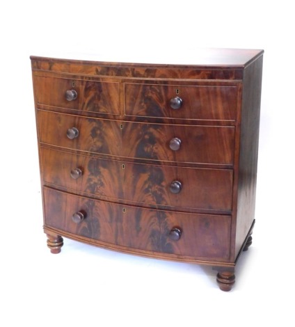 A Victorian mahogany bow fronted chest of two short and three long cock beaded drawers, on triple bun feet, 110cm high, 102cm wide, 49cm deep.