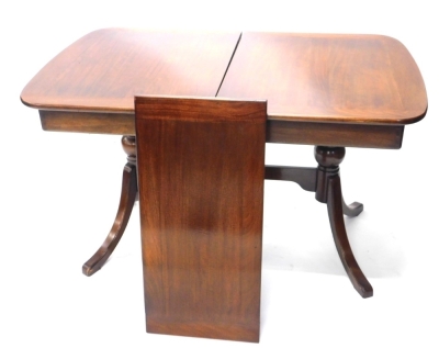 A 20thC mahogany extending dining table, of D end form, with leaf, on saber legs, when closed, 75cm high, 122cm wide, 80cm deep.