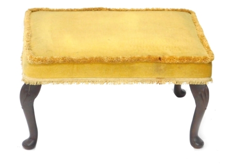 A walnut framed footstool, overstuffed in yellow material, on cabriole legs, 35cm high, 52cm wide, 40cm deep. The upholstery in this lot does not comply with the 1988 (Fire & Fire Furnishing) Regulations, unless sold to a known exporter or upholsterer it 
