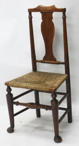 An 18thC fruitwood country chair, with comb top, hourglass splat, rope seat, and turned front legs terminating in pad feet, 101cm high.