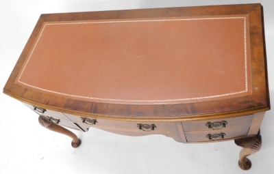 A 20thC walnut writing desk, with later tooled leather top, above central drawer flanked by four further drawers, on cabriole legs terminating in pad feet, 78cm high, 103cm wide, 51cm deep. - 2