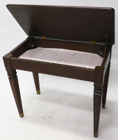 A modern mahogany piano stool, of rectangular form with hinged lid and vacant interior, on square tapering legs, 57cm high, 65cm wide, 39cm deep.