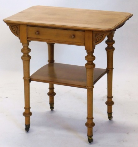 A late 19thC satinwood side table, the plain top above a frieze drawer, on turned legs joined by an under tier and terminating in pot castors, 74cm high, 78cm wide, 39cm deep.