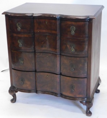 A 20thC Anglo Dutch style block front chest of four long drawers, on shell capped squat cabriole legs terminating in pad feet, 84cm high, 77cm wide, 45cm deep.