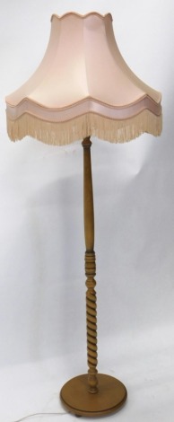 A lamp standard, with pink shade, 156cm high.