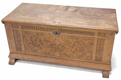 A heavily carved 19thC French oak coffer, the rectangular top revealing a plain interior, above a heavily carved front decorated with scrolls and flowers, on scroll feet, 59cm high, 126cm wide, 63cm deep.