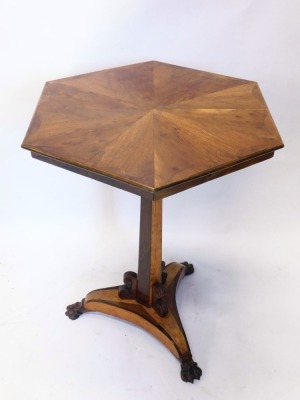 A 19thC mahogany and yew wood specimen table, the hexagonal top inlaid with various sections, on a turned stem and platform base terminating in hairy paw feet, the top 69cm wide.