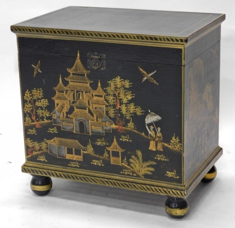 A 20thC Japanned black lacquer box, profusely decorated with buildings, birds, and figures, on bun feet, 56cm high, 51cm wide, 35cm deep.