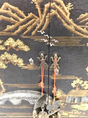 A 20thC Japanned lacquered cabinet, profusely decorated with buildings, trees, boat, and hills, with two doors above three drawers, on block base, 121cm high, 65cm wide, 41cm deep. - 2