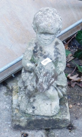 A classical style stone garden statue of a child, on square base, 42cm high. (heavily weathered)