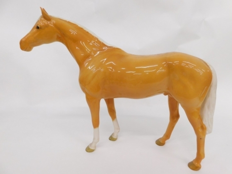 A Beswick pottery hunter horse, Palomino, marked beneath, 30cm high.