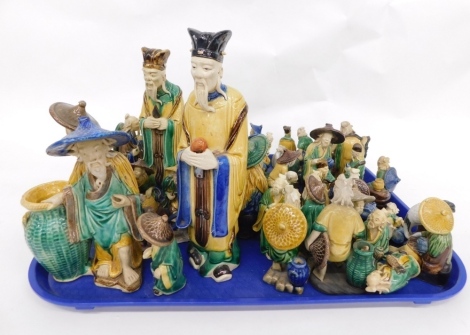 Various Chinese Tang style pottery figures of gentleman, to include a bearded sage, 22cm high, each similarly decorated in flowing robes, predominantly in yellow, green, and blue.