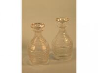 A pair of 19thC mallet shaped cut glass decanters and stoppers