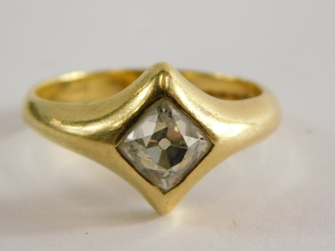 A diamond set single stone ring, set with cushion shaped old mine cut diamond, approximately 5.7 x 5.5 x 4.6mm, totally approximately 1.10 cts, in a rub over kite shaped setting, the band stamped 18ct, Birmingham convention marks, ring size N½, 5.9g all i