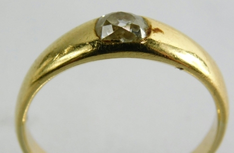 An 18ct gold solitaire ring, set with old cut diamond approx 0.23 carats in a rub over setting, the yellow metal band stamped 18ct, ring size Q, 4.1g all in.