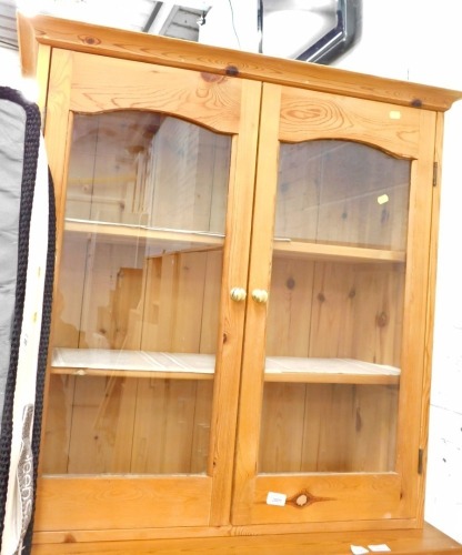 A pine side cabinet, with glazed front.