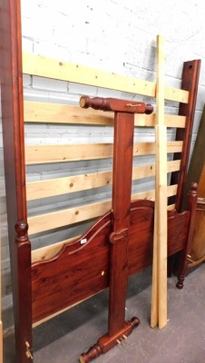 A pine kingsize bed frame, with headboard, footboard, and supports.