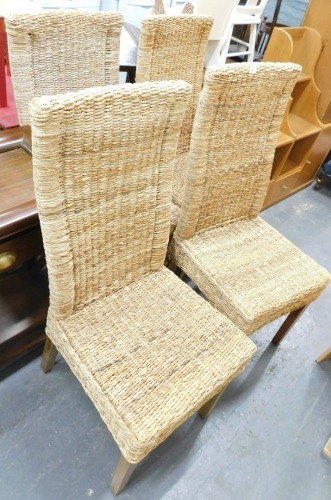 A set of four rope seated dining chairs.