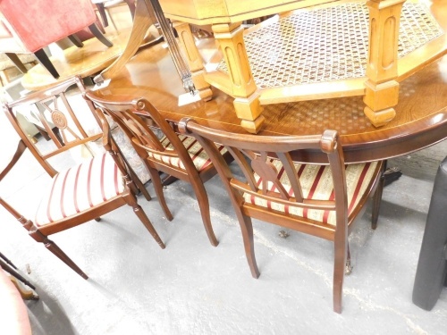 A mahogany finish Regency style dining suite, comprising D end dining table and four chairs and two carvers, in Regency striped material.