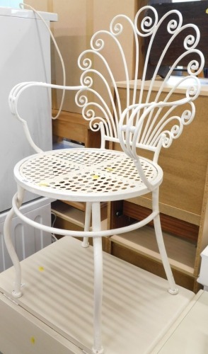 An iron scroll back chair in white, with pierced seat.