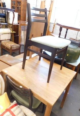 Two ladderback chairs and a small square dining table.