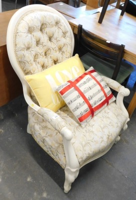 A spoon back armchair in cream.