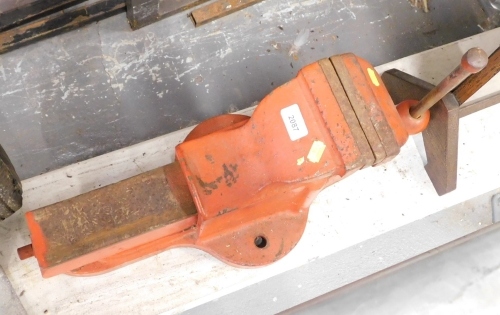 A large metal vice in red.