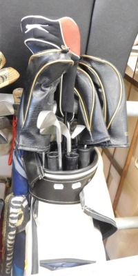 Various golf clubs.