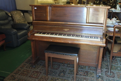 A Lambert oak cased metal over strung piano and matching stool.