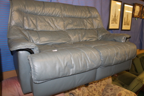 A modern grey two seater leather sofa.