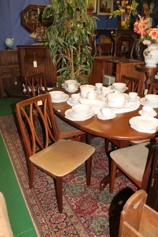 A oval G Plan extending table and six chairs.