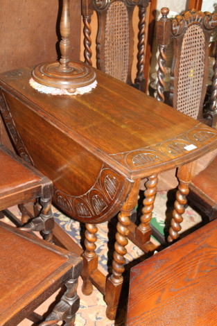 A carved oak barley twist drop leaf table.