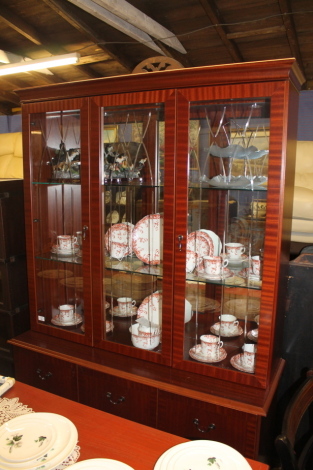 A modern William Morris teak wall unit, with mirrored back and glass shelves and three cupboards below.