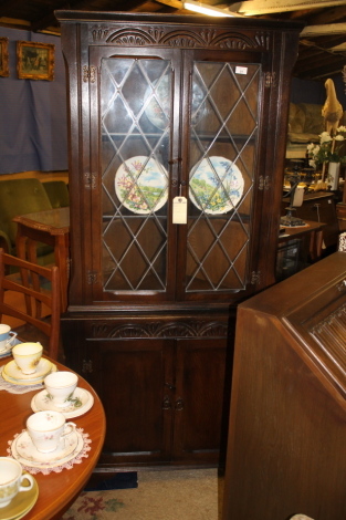 A dark wood corner cabinet.