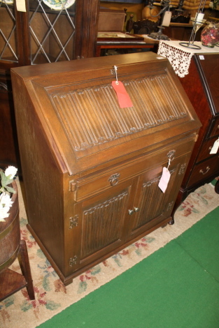 An Old Charm linen fold oak bureau.