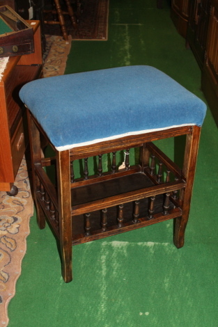 An upholstered early 20thC piano stool.