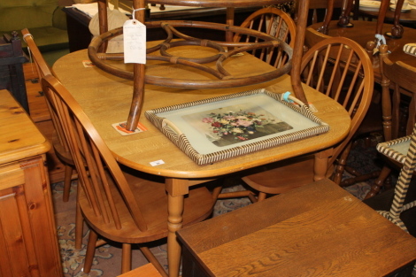 Four stick back chairs and a draw leaf table.