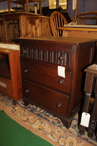 An oak small three drawer chest.