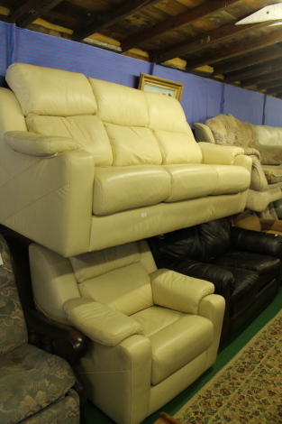 A leather upholstered three seater sofa and matching chair.