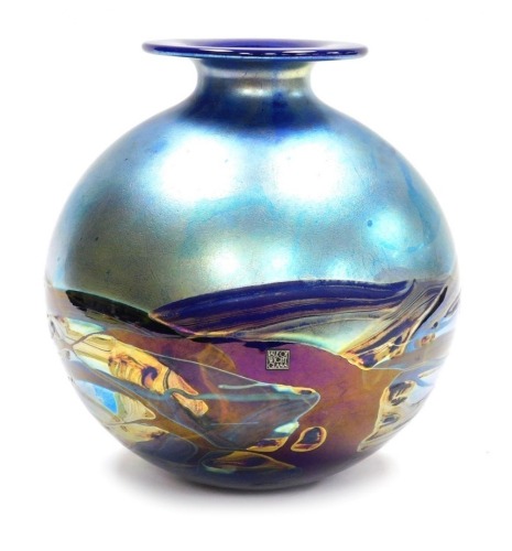 A Michael Harris Isle of Wight glass 'Nightscape' vase, of globular form with a short neck and flat rim, decorated with iridescent trails against a blue ground, with paper label and signed to underside, 26cm high.