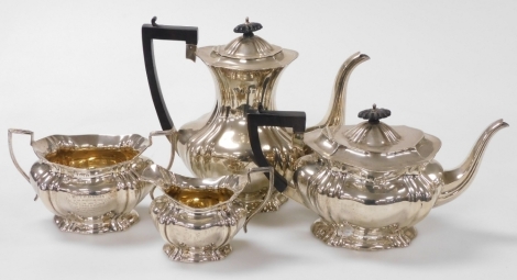 An Edward VII silver four piece tea and coffee set, of fluted form, presentation engraved 'presented to Mr T.D. Bourn by the members and friends of the Clitheroe Cricket and Bowling Club in recognition of 21 years valuable service March 29th 1905', compri