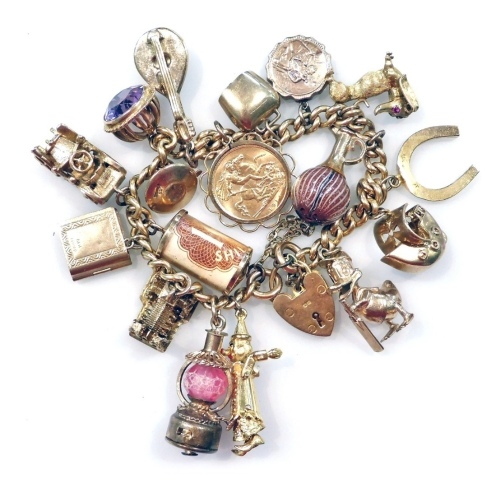 An 18ct gold curb link charm bracelet, on a heart shaped padlock clasp, with safety chain as fitted, having seventeen 9ct gold and other metal charms, including a George V gold half sovereign 1914, 100.58g all in.