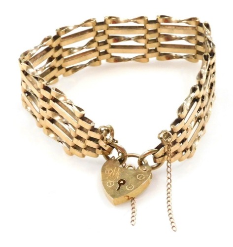 A 9ct gold five bar gate bracelet, on a heart shaped padlock clasp, with safety chain as fitted, 17.7g.