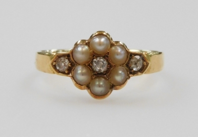 An 18ct gold diamond and pearl flower head ring, set with six pearls and three diamonds, size N, 2.7g.