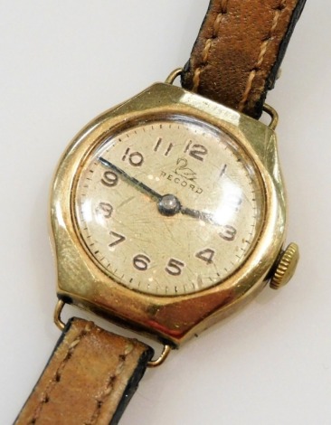 A Record lady's 9ct gold cased wristwatch, circular silver dial bearing Arabic numerals, Swiss 15 jewelled movement, on a leather strap.