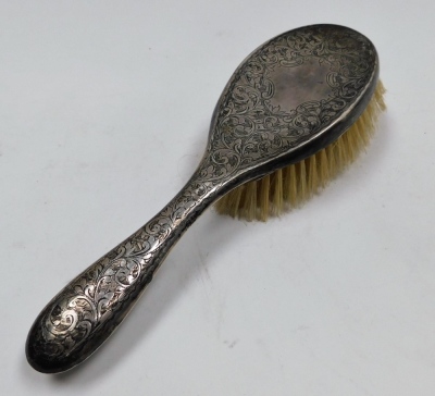 An Edward VII silver backed three piece dressing table set, comprising hand mirror, hair brush and comb, each piece engraved with scrolls and leaves, Chester 1901, together with two further silver backed clothes brushes. - 4