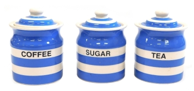 A set of three TG Green Cornishware pottery kitchen jars, comprising Tea, Sugar, and Coffee, in banded blue and cream, printed marks, each 18cm high.