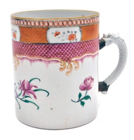 An early 19thC Chinese export famille rose porcelain mug, of large proportion, the upper band decorated with reserves of flowers, against an orange gilt cross hatched band above a further pink scale band, the main body decorated with flowers, with a mould