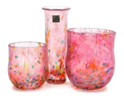 Three Isle of Wight glass 'Summer Fruits' vases, designed by Timothy and Jonathan Harris, comprising cylindrical vase bearing paper label, 13cm high, and two vases of compressed form, 10cm high and 7.5cm high, cranberry colourway, unsigned, all boxed.